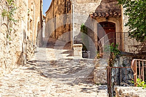 NarrowÂ cobblestone streets limestone medieval buildings of ancient notoriously famous Lacoste town at summer. Vaucluse, France